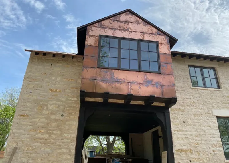 Copper metal panel facade on a stone building for Roof Repair in West Chicago