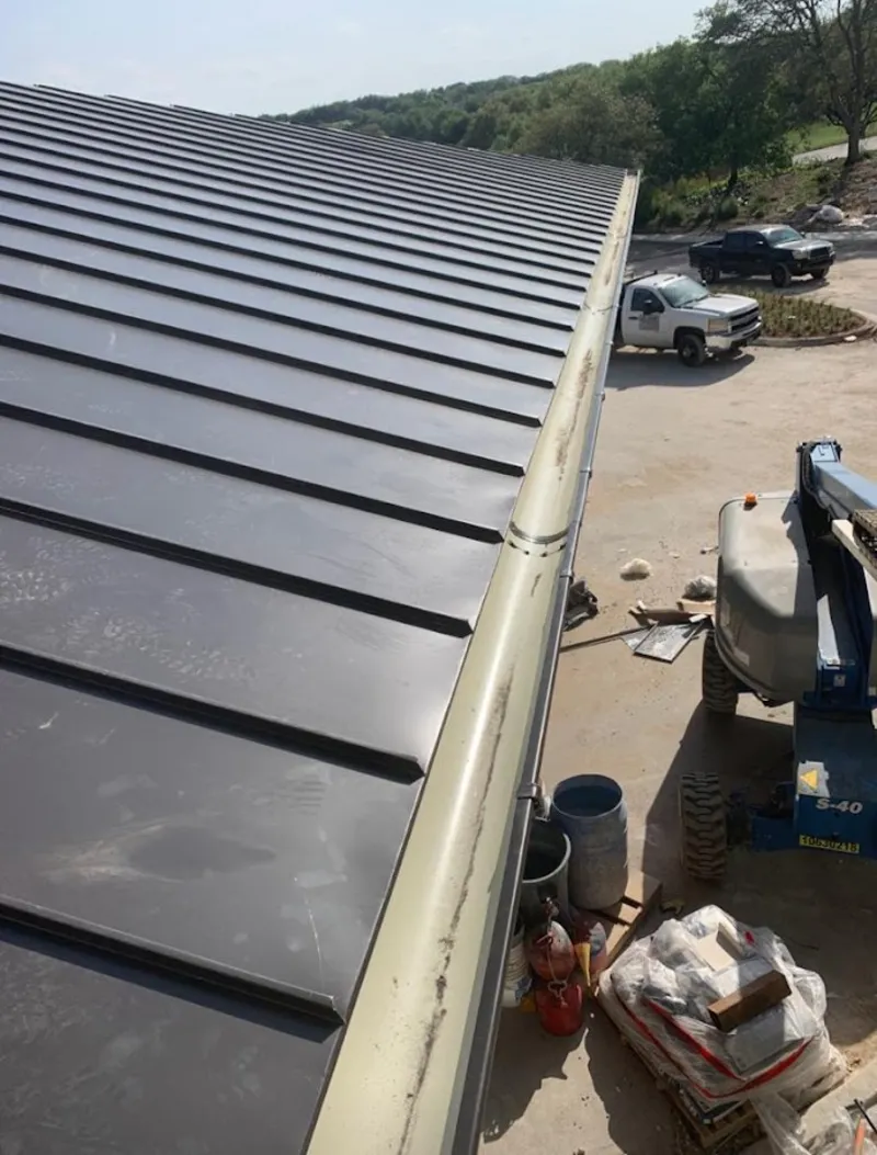 Standing seam panel and gutter detail on a metal roofing jobsite in West Chicago